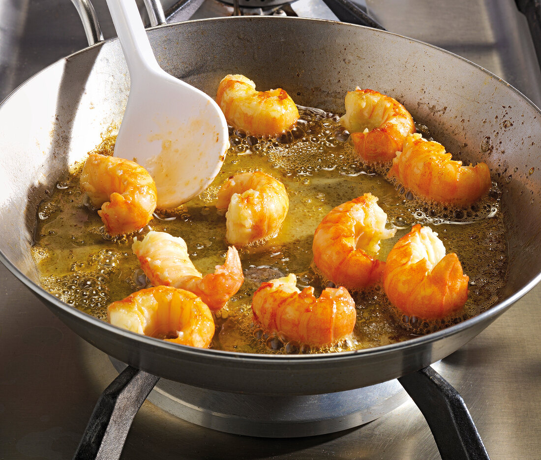 Close-up of crawfish being fried in saucepan