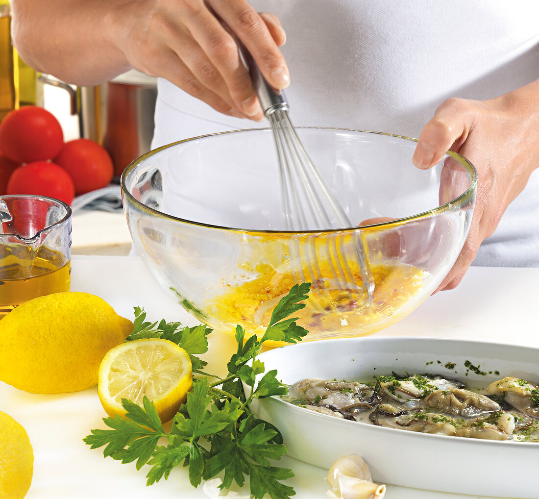 Close-up of hand whisking mayonnaise in bowl