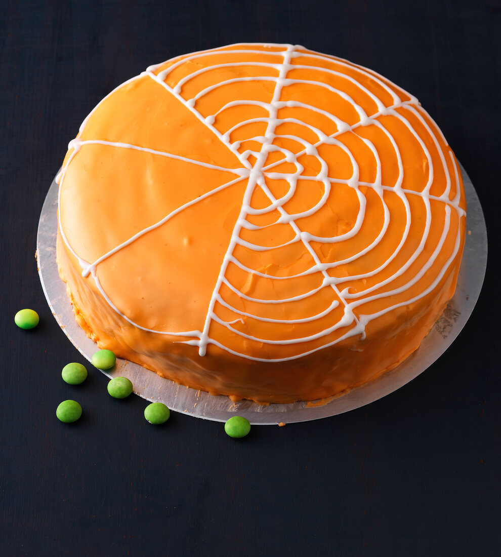 Close-up of half decorated orange cake