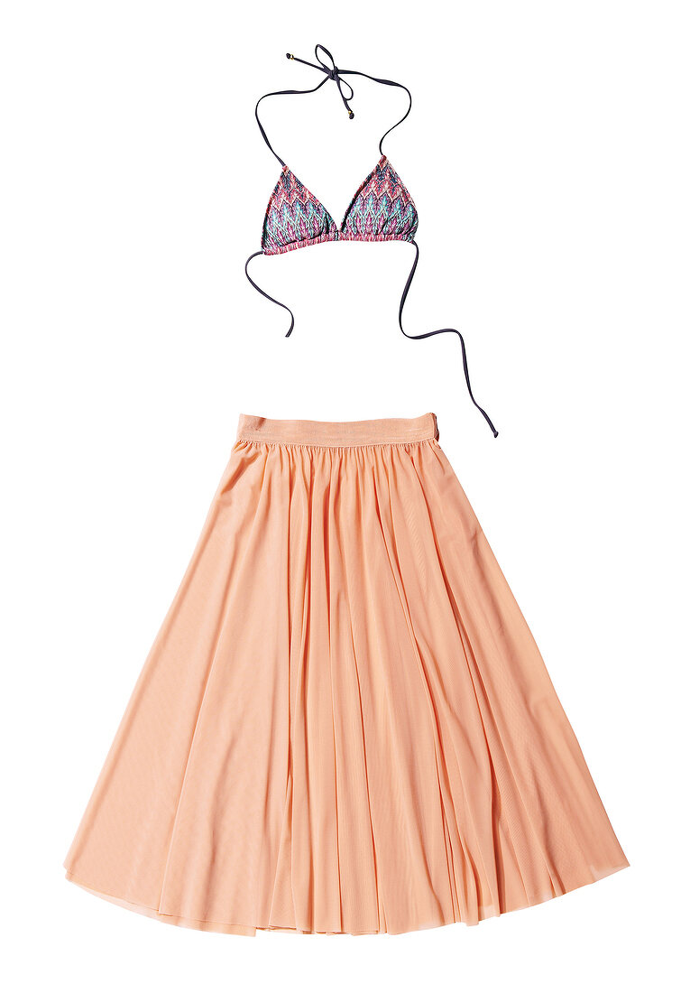 Bikini top and wide-swinging pleated skirt in retro style on white background
