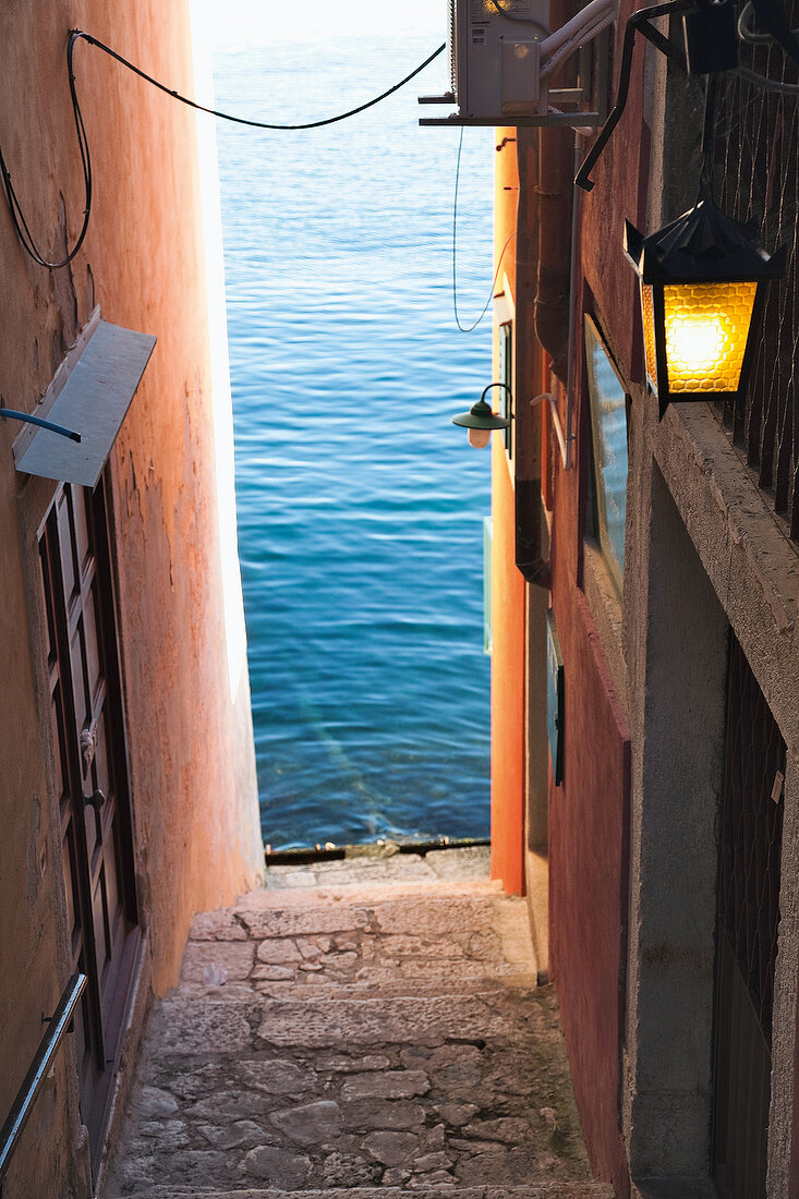 View of sea from Old Town alley in Rovinj, Croatia