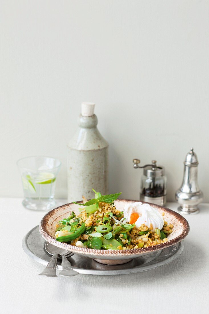 Bulgur with green vegetables, mint and poached eggs
