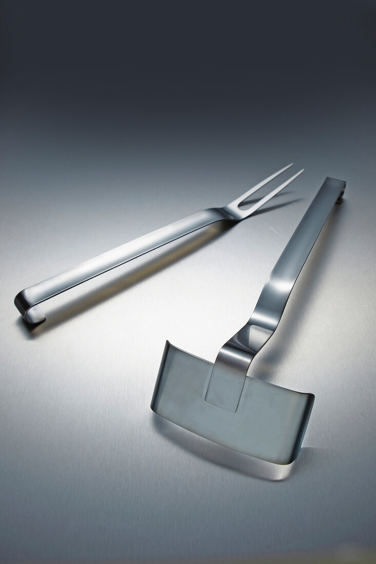 Close-up of BBQ accessories such as stainless steel fork and shovel