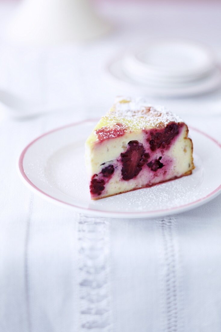 A slice of blackberry cheesecake on a plate