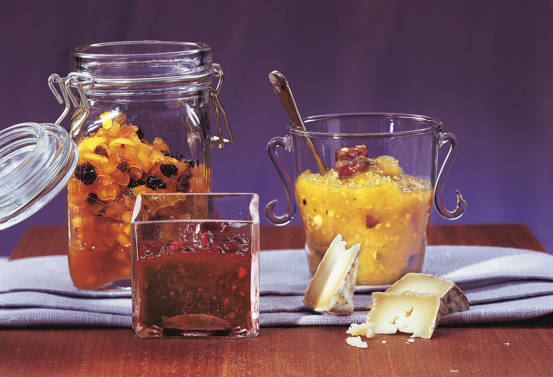 Different types of fruit chutneys in glass containers