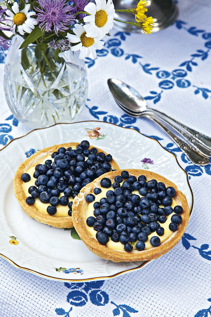 Tartlets with blueberries on plate