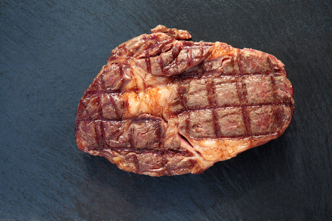 Piece of steak on black background