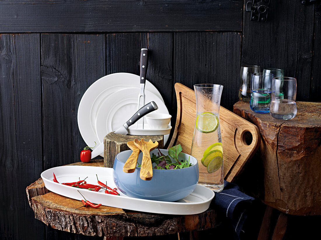 Bowl of vegetables, jug and glass on wooden block