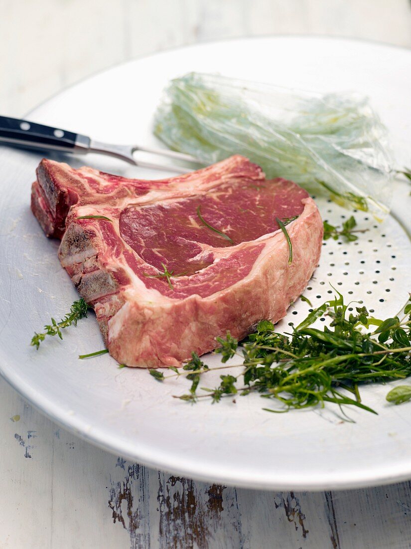 Argentinian steak being marinated with herbs and olive oil