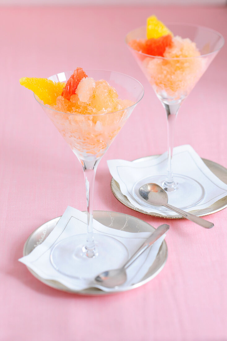 Pink grapefruit granita with vodka splash in martini glasses