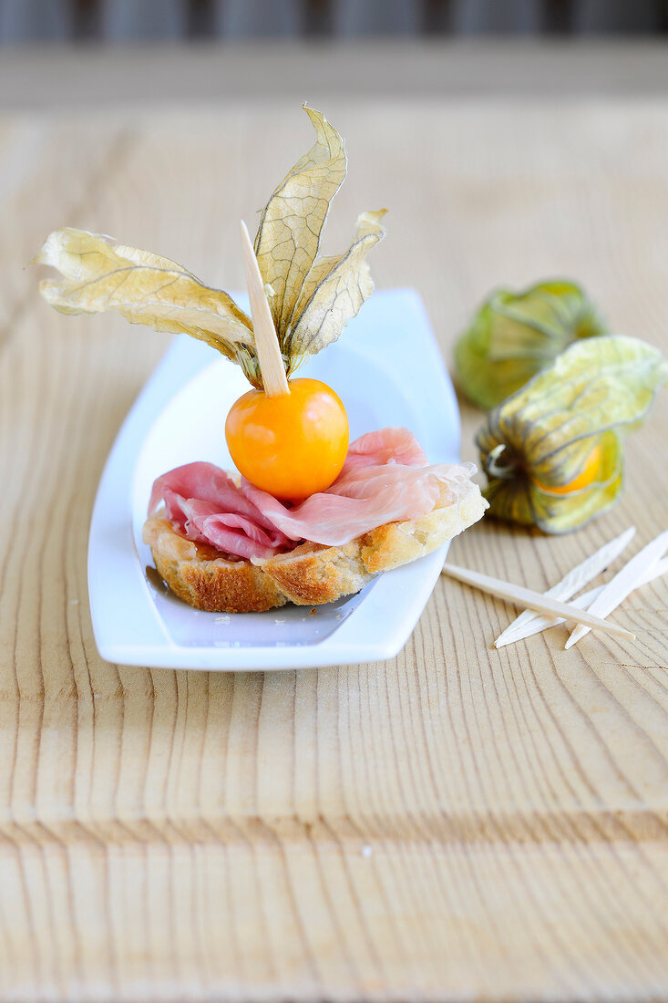 Ham canapes on plate