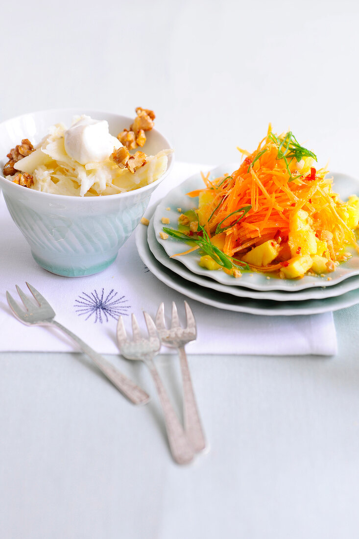 Bowl of waldorf salad and apple carrot salad on plate