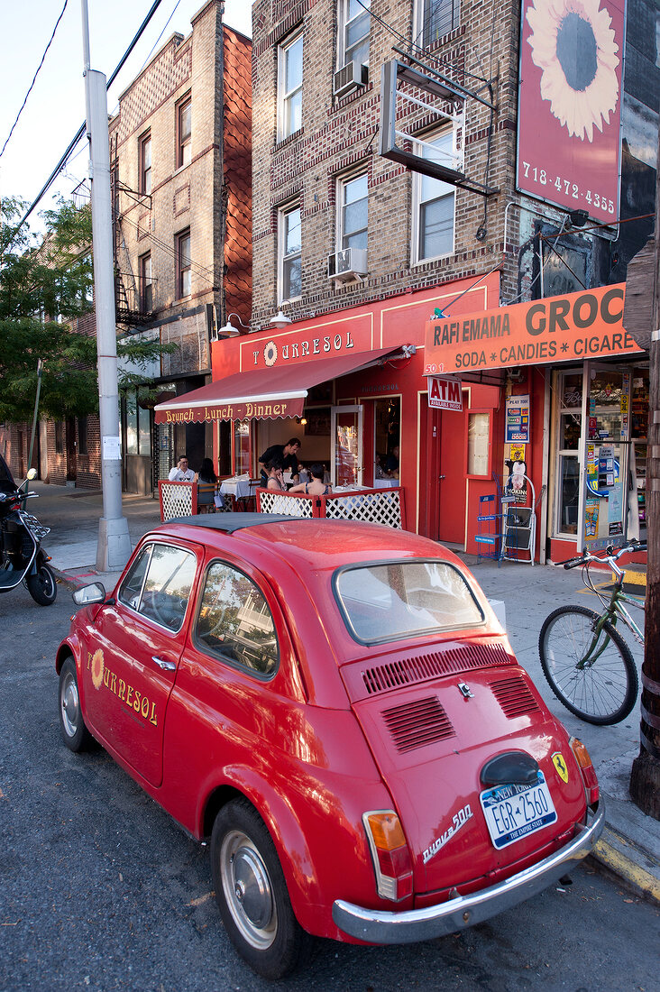 Red car parked on streets in Brooklyn, New York, USA