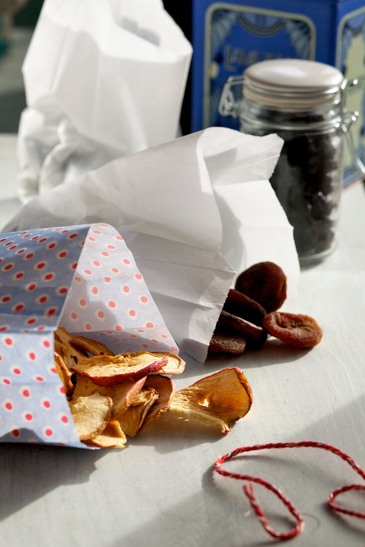 Dried apples and apricots in paper bags