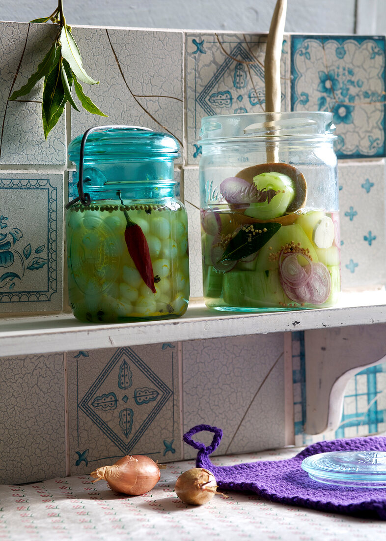 Homemade pickled gherkins with onions in jars