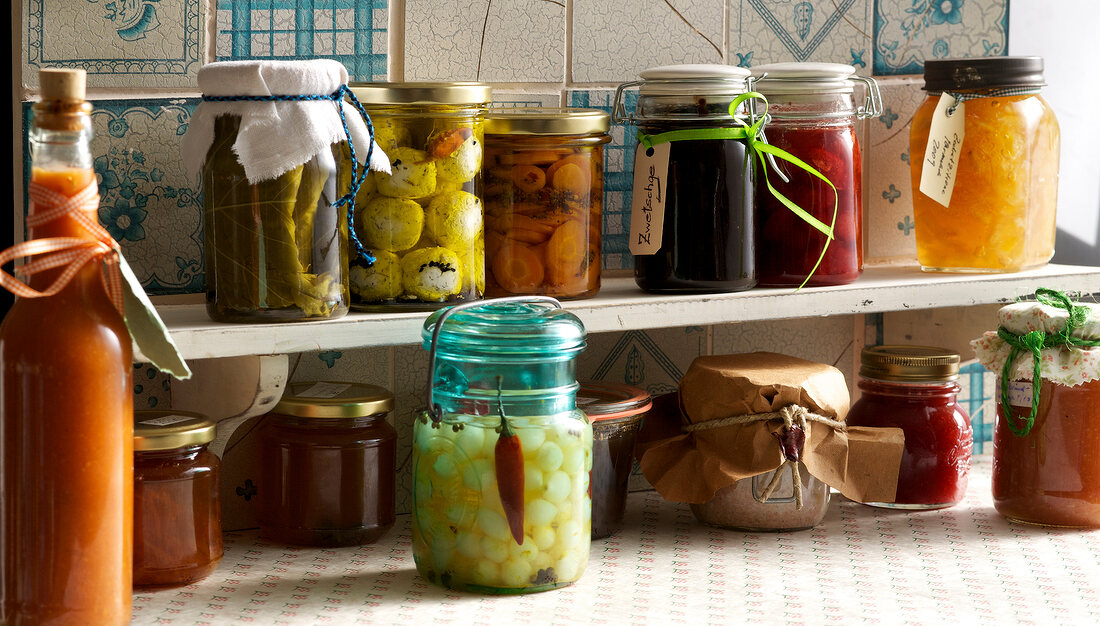 Preserved foods in jars on shelf