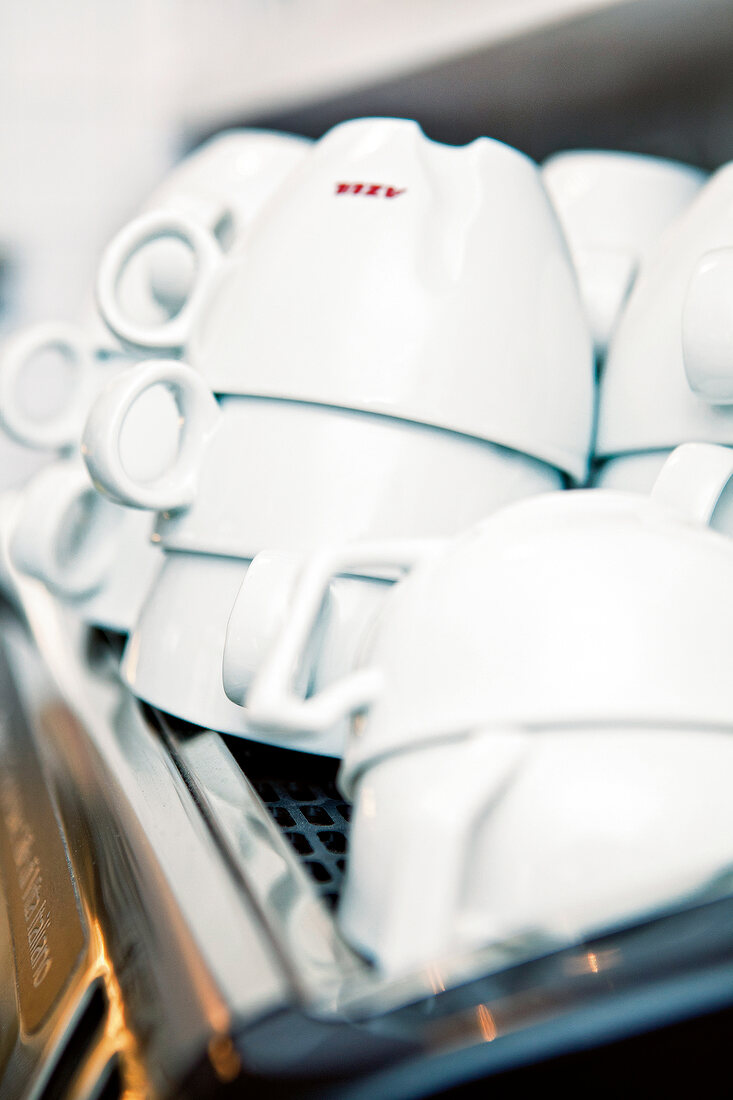 Close-up of stack of white coffee cups