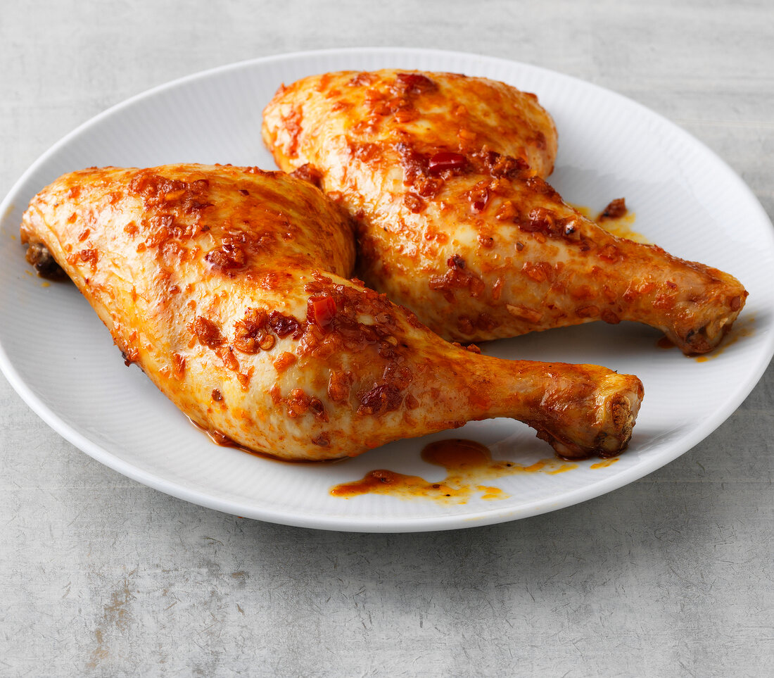 Spicy chicken legs on plate