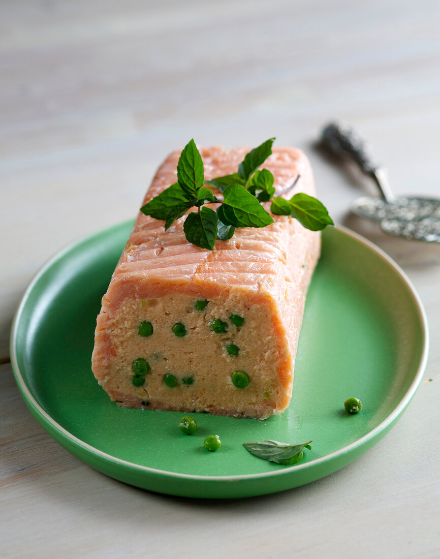 Salmon terrine with green peas on plate