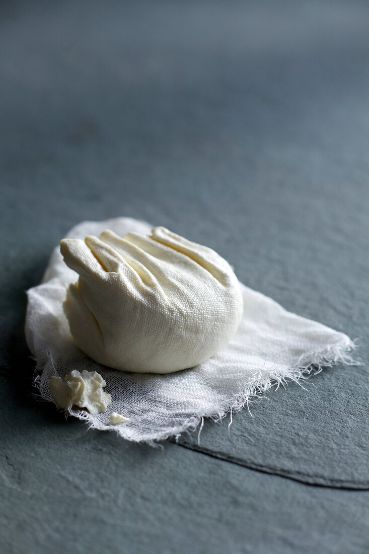 Homemade cream cheese in cheesecloth
