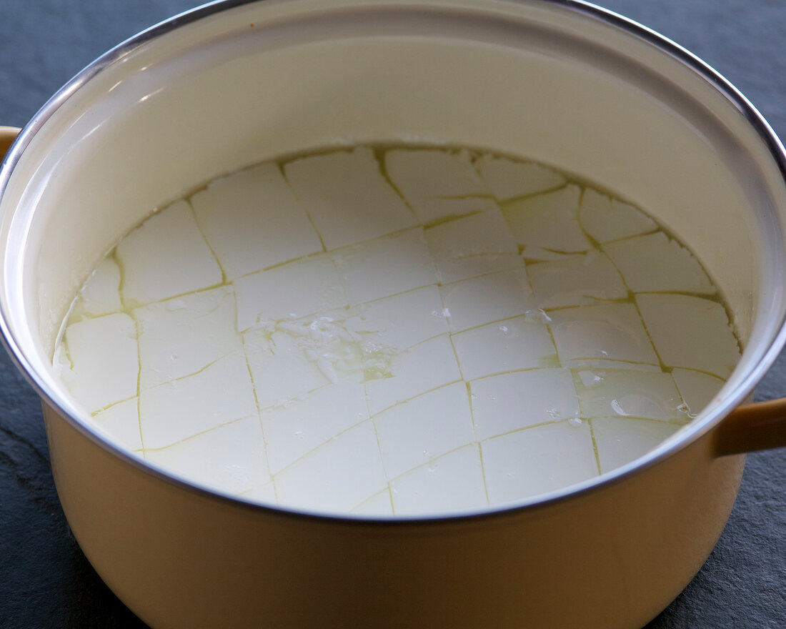 Close-up of whey separates from milk in casserole