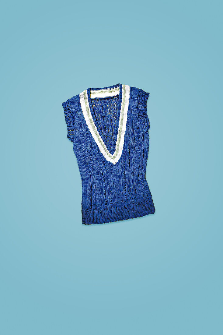 Blue v-necked tank top sweater on blue background