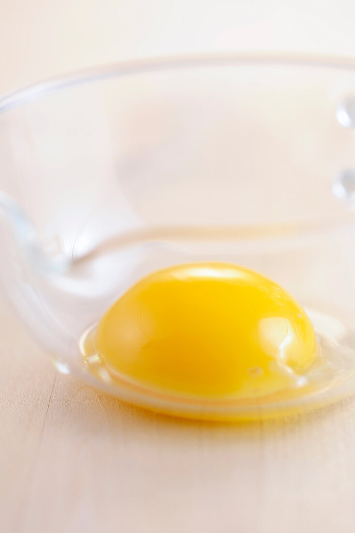 Close-up of egg yolk in glass bowl 