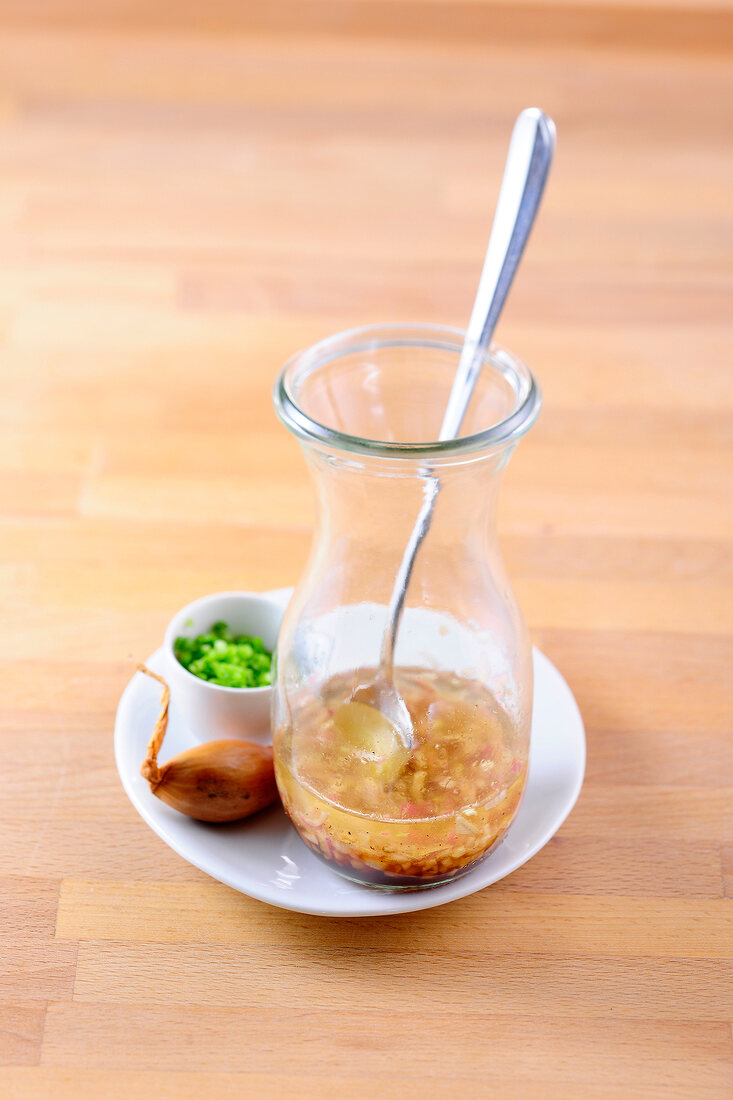 Sherry vinaigrette with shallots in glass jar with spoon