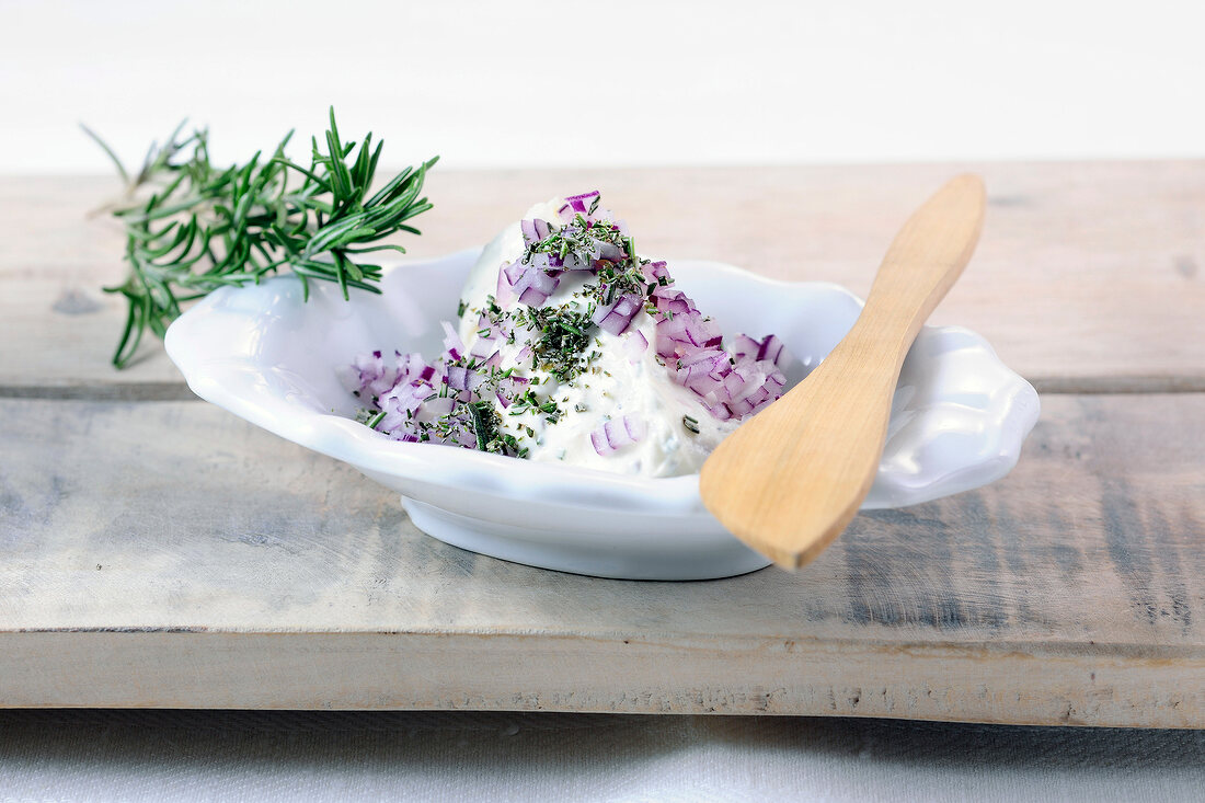 Goat cream cheese dip with honey in serving dish