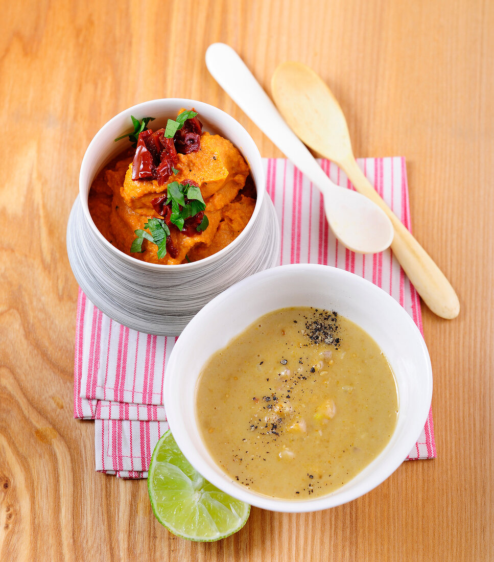 Red lentil dip and peanut-coconut dipping sauce in bowls