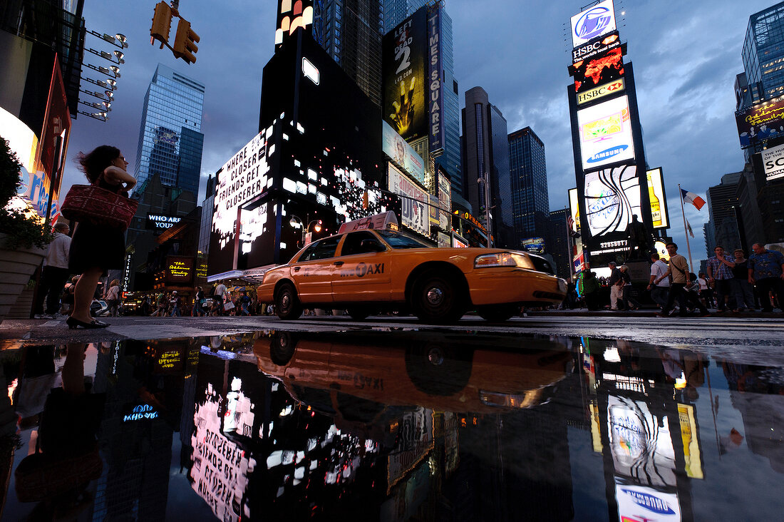 Taxi in front of Times Square at dusk, New York