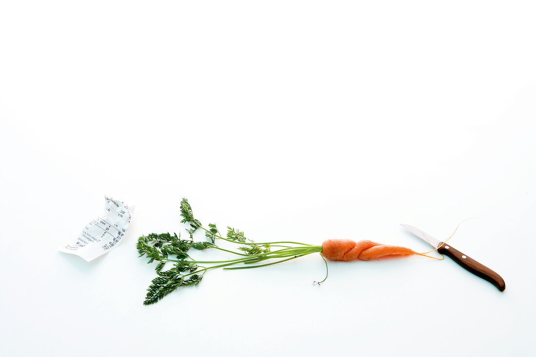 Carrot, bon and knife on white background