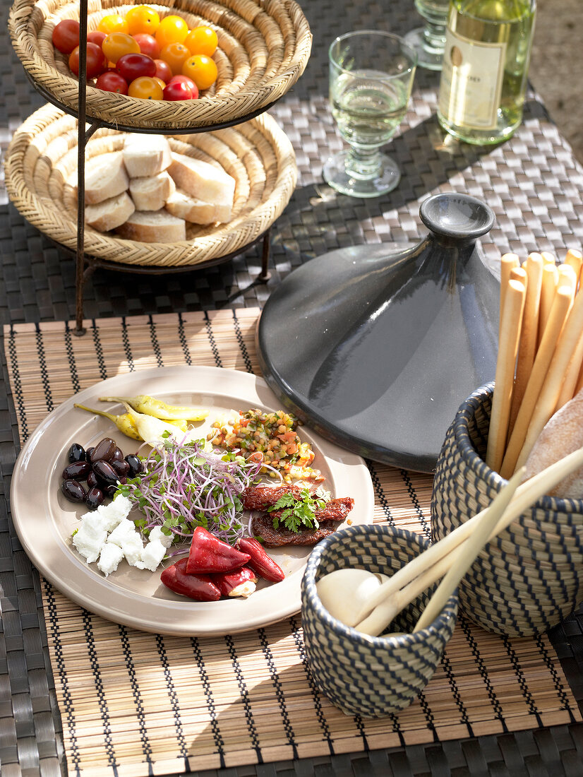 Arabic appetizers, tajine, bread, cherry tomatoes and wine