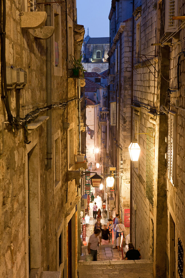 People at Dubrovnik old town alley and stairs in Croatia, in Evening