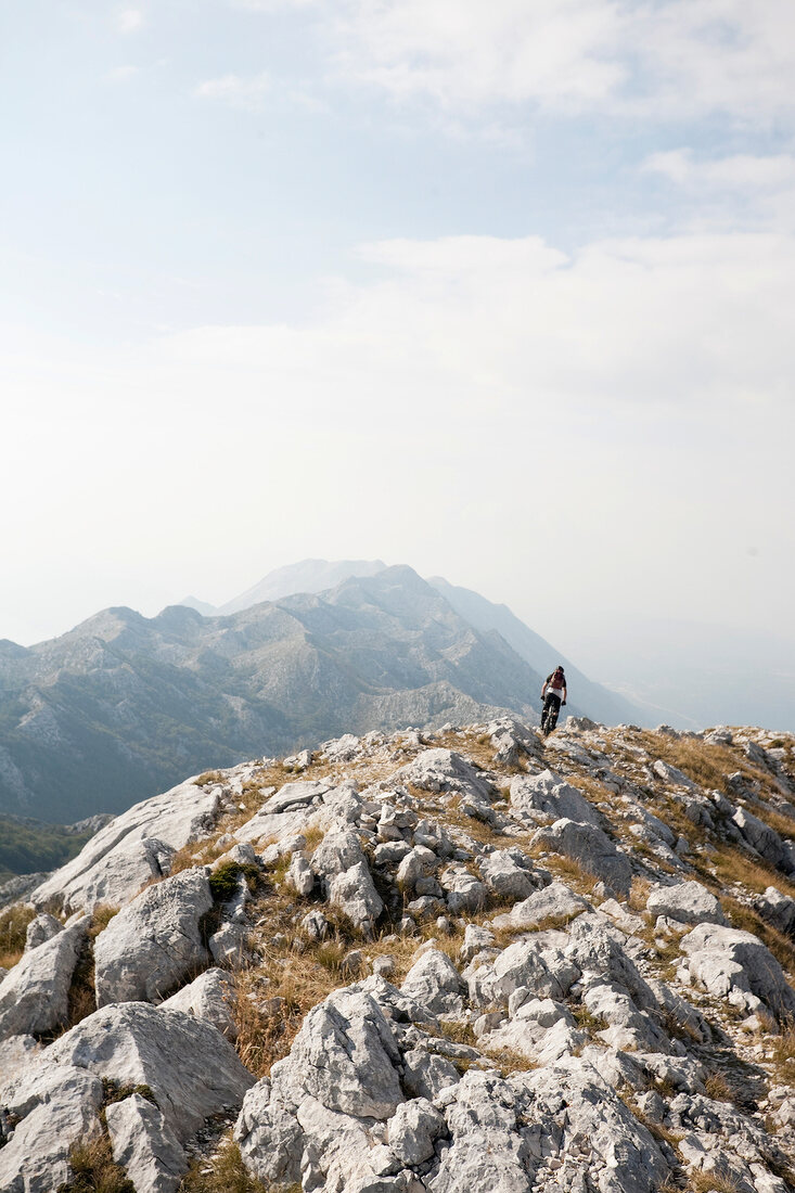 Biker riding bike on Mount Sveti Jure in Dalmatia, Croatia