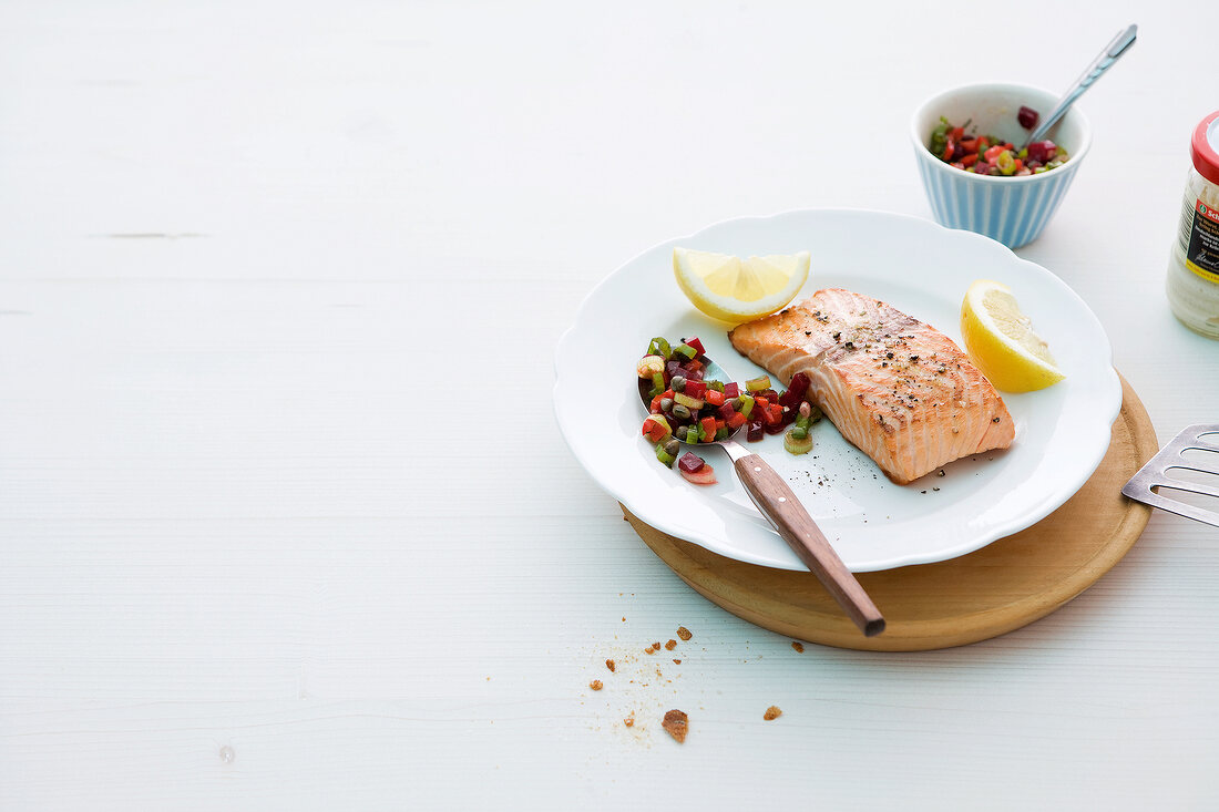 Salmon fillet with beetroot salsa on plate
