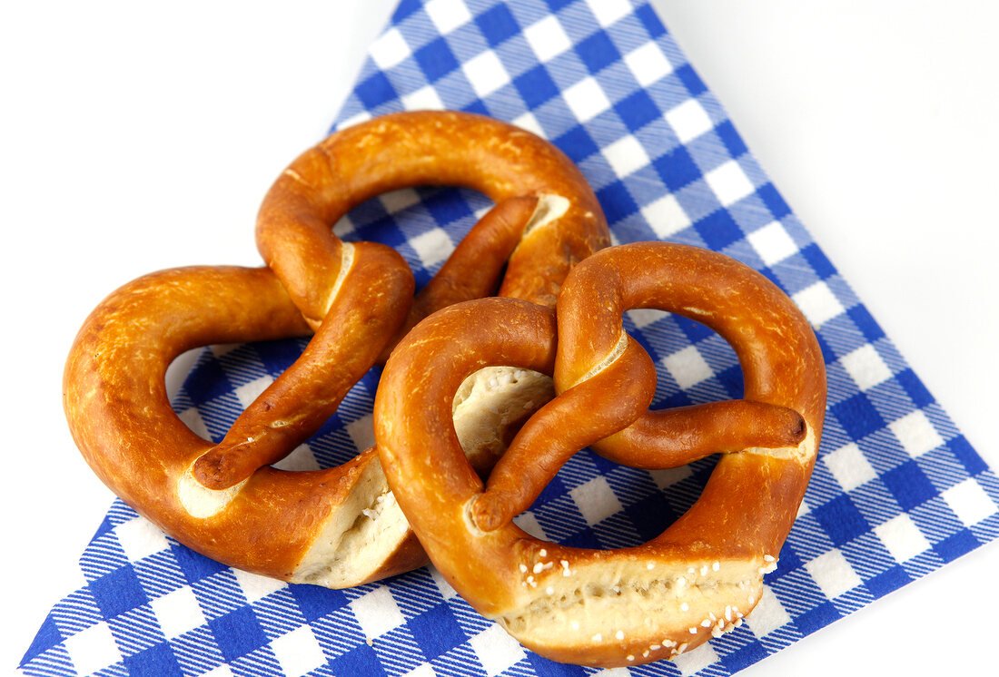 Two pretzels on blue checked napkin