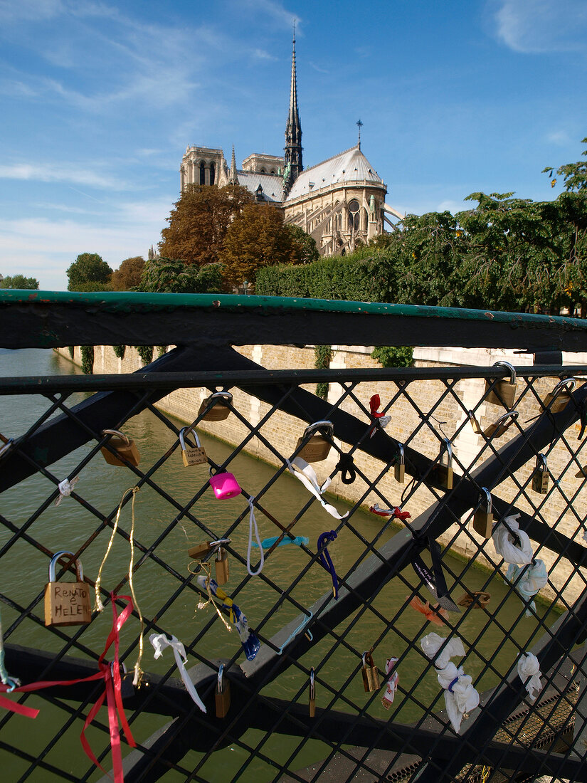 Bridge with love castles overlooking Notre Dame cathedral, Paris, France