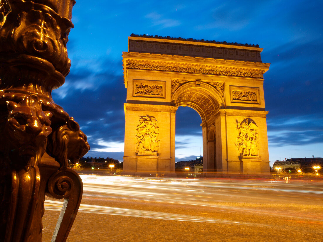 People walking in front of Arc de Triomphe on Place Charles de Gaulle in Paris, France