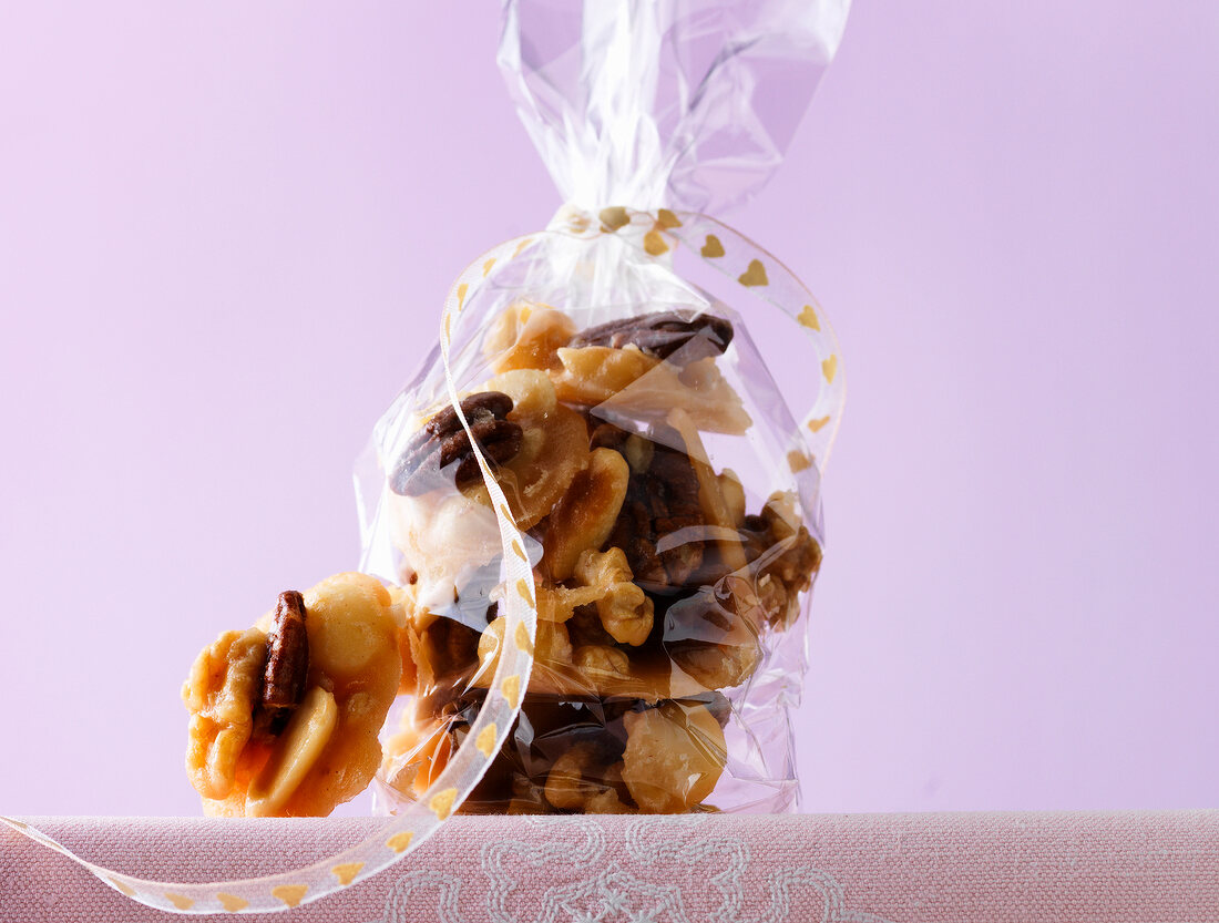 Close-up of caramel nuts in cellophane bag