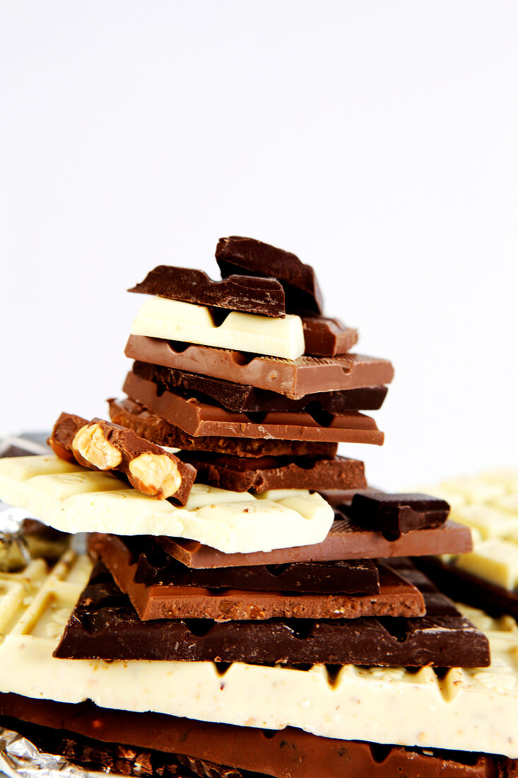 Different types of chocolate bars on white background