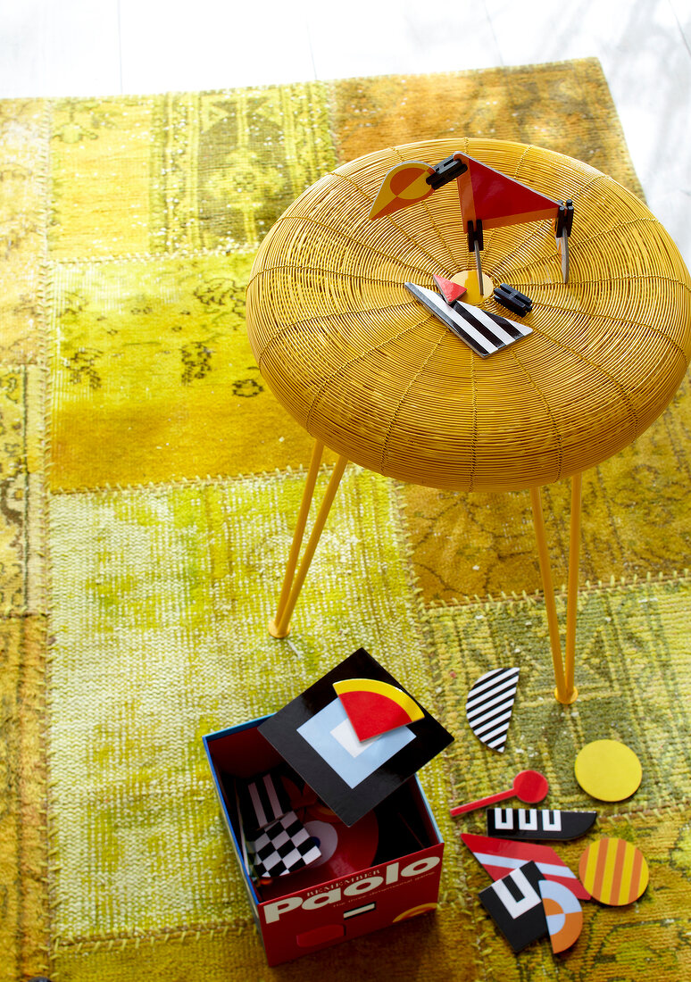 Elevated view of rug stool on yellow carpet