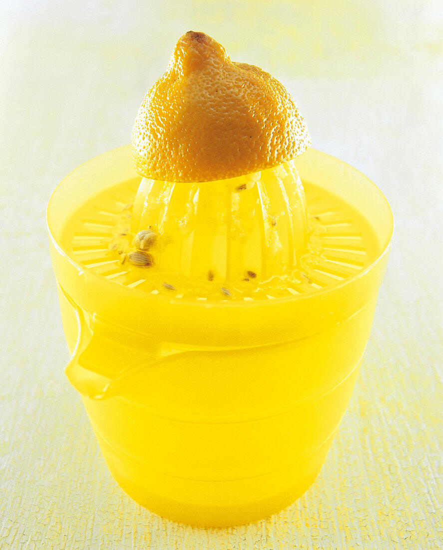 Close-up of half lemon on lemon squeezer