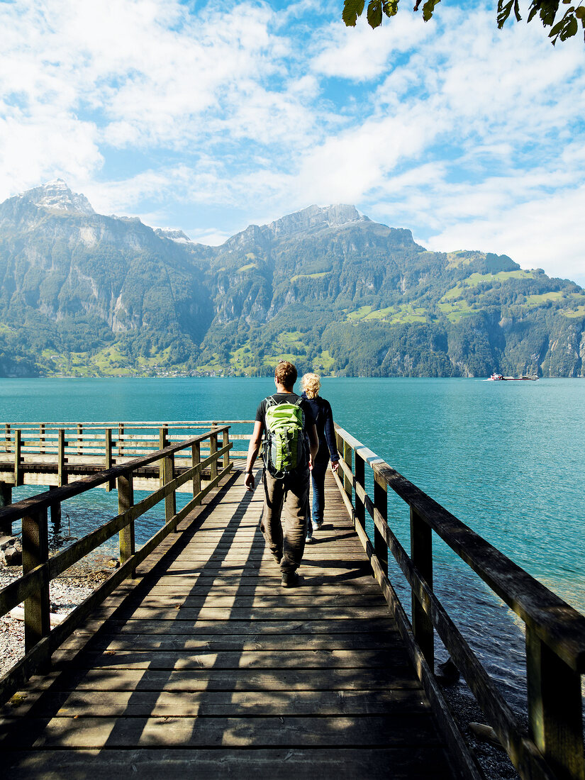 Tourists walking on jetty in Lake Lucerne, Alps, Lucerne, Switzerland