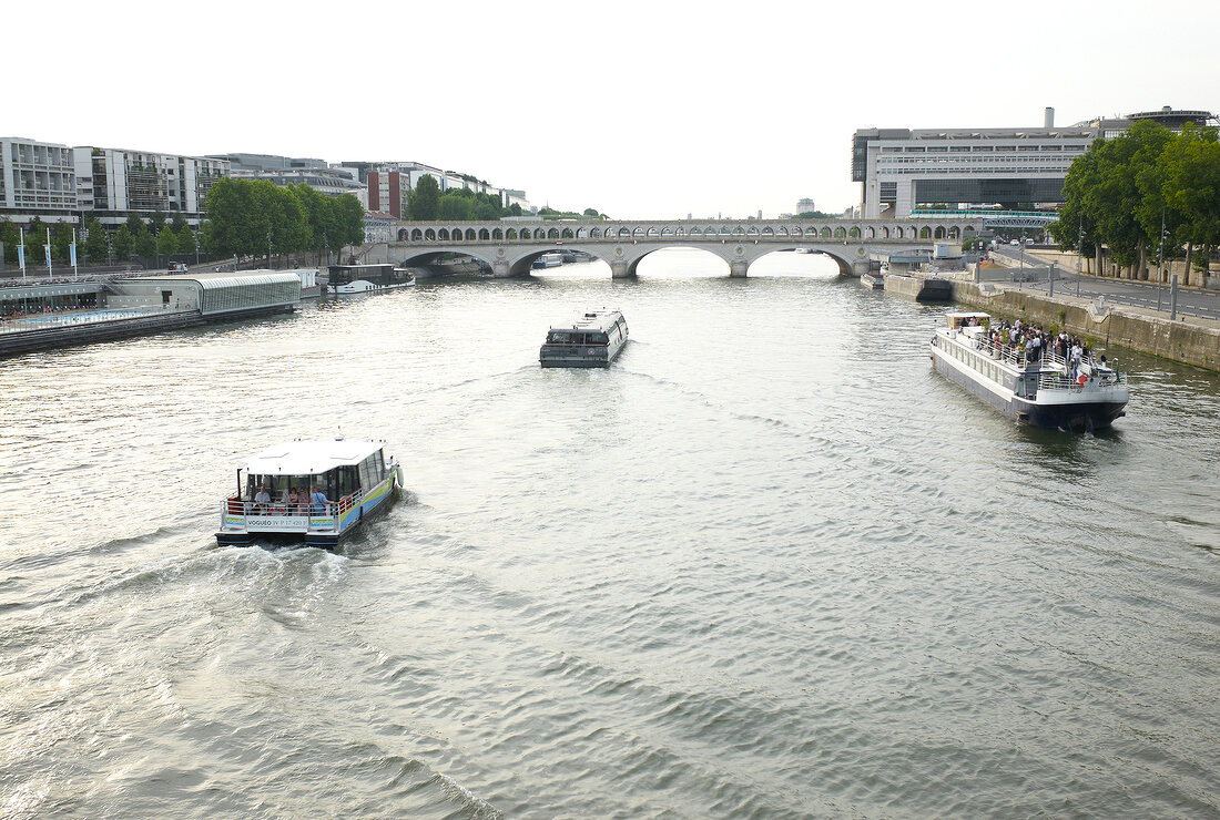 View of Ferry boats and arch bridge on Seine river, Paris, France