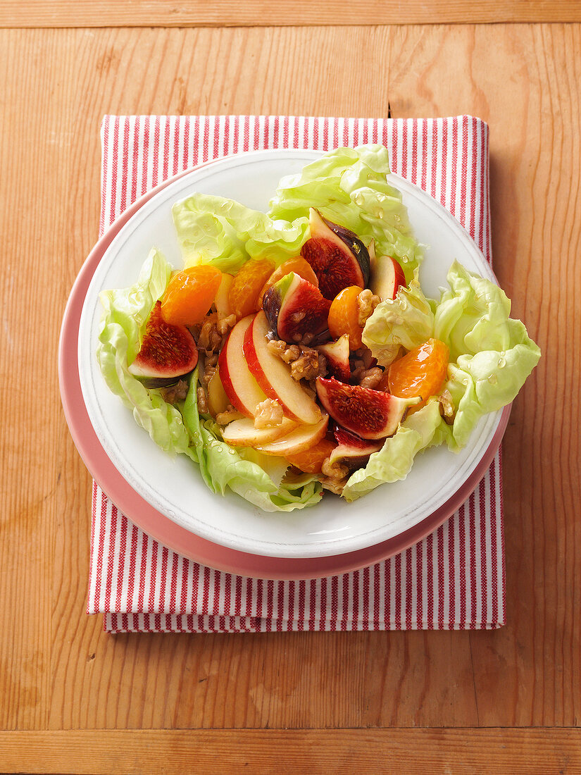 Fruit salad with walnuts on plate