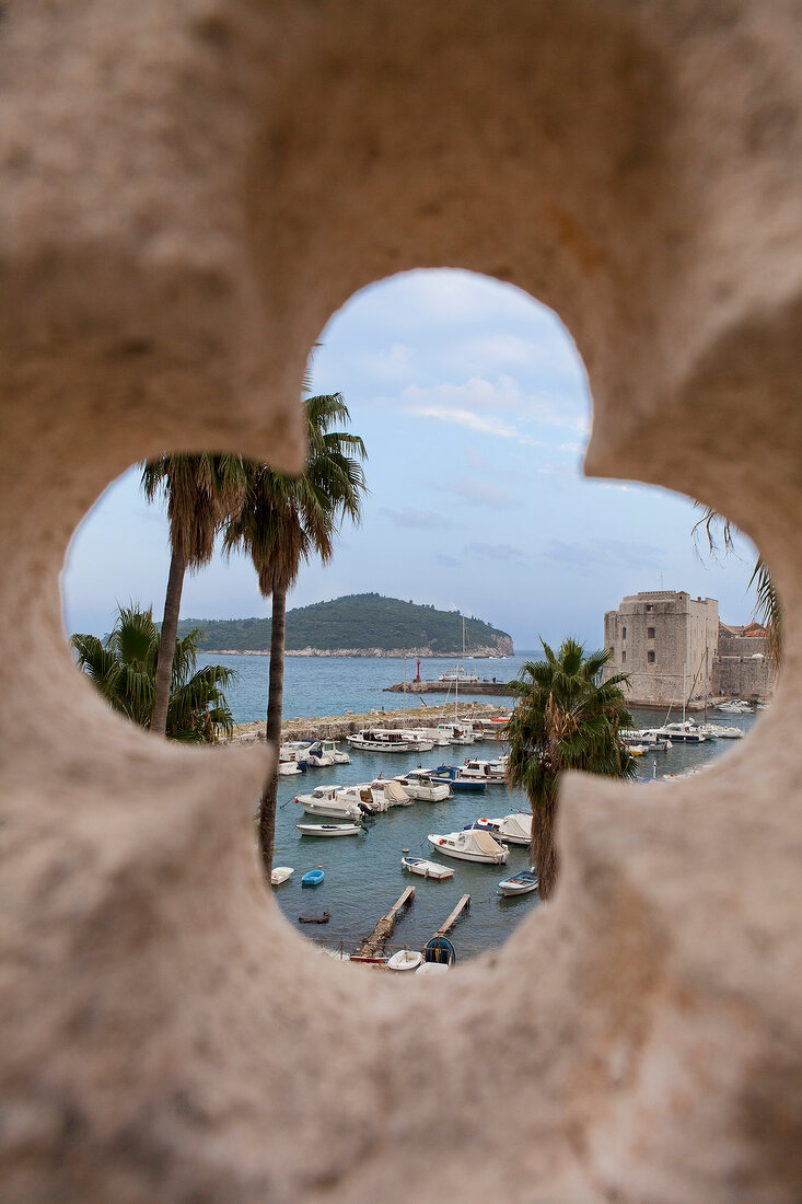 View of harbour and island through window embrasure of city wall in Dubrovnik, Croatia