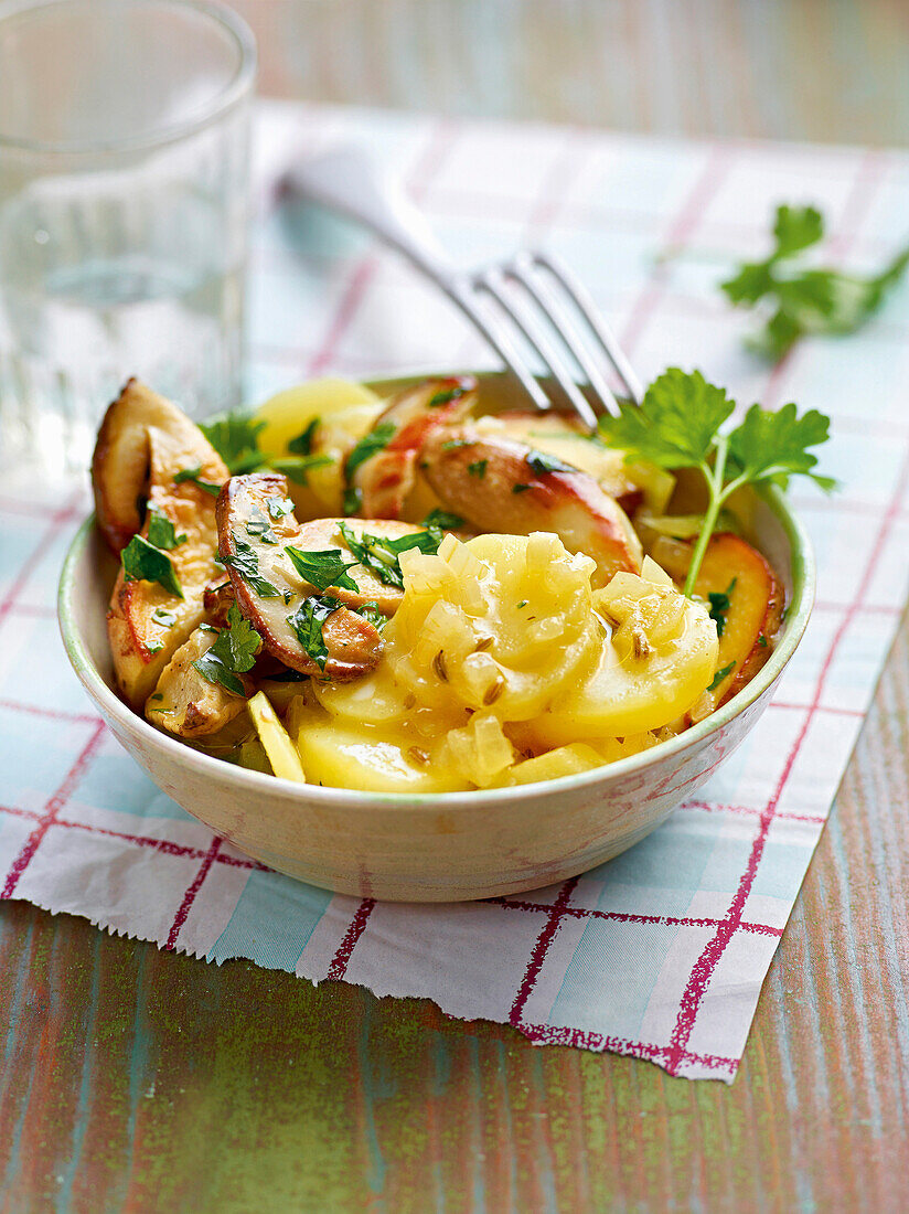 Lukewarm potato salad with porcini mushrooms in bowl