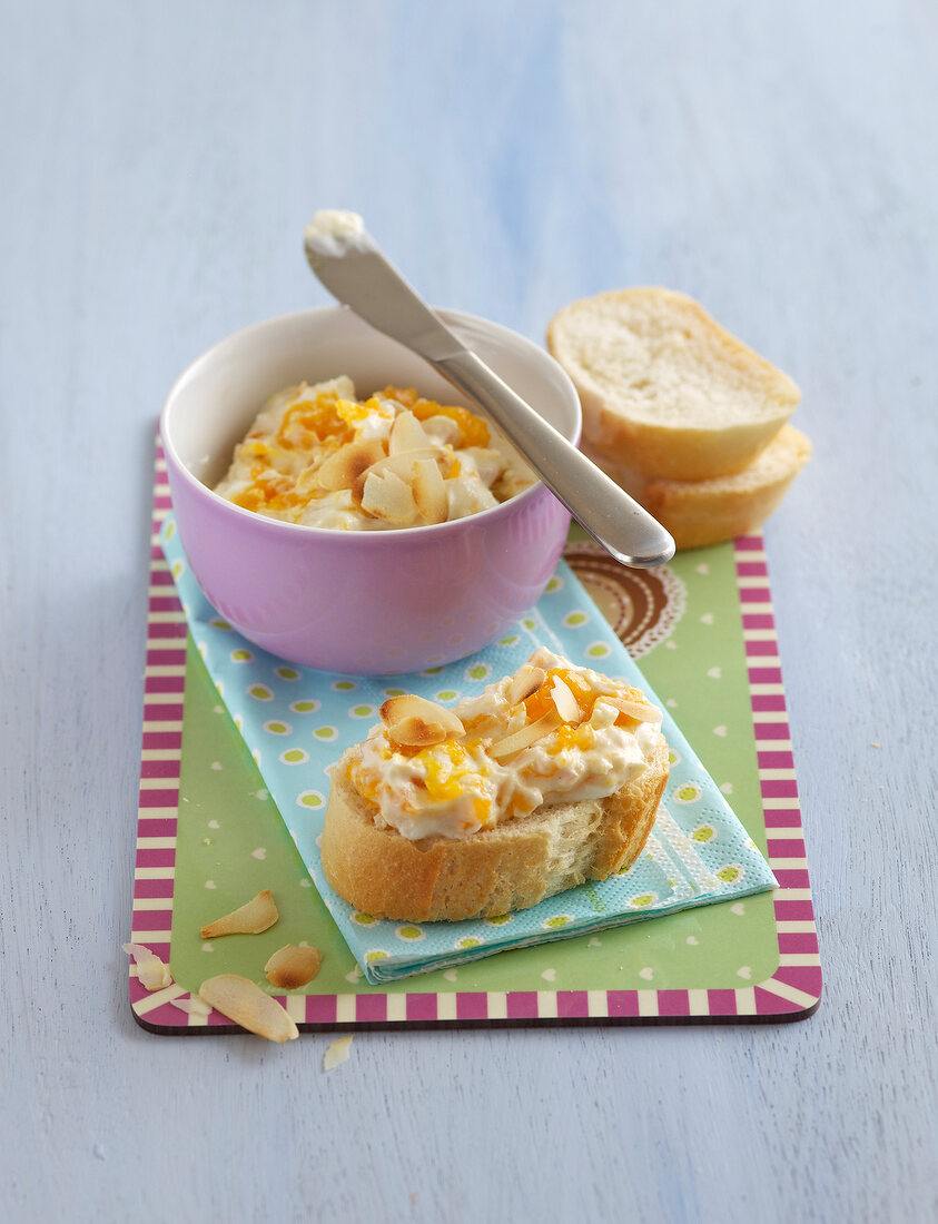 Bowl of ricotta and apricot spread and slices of bread