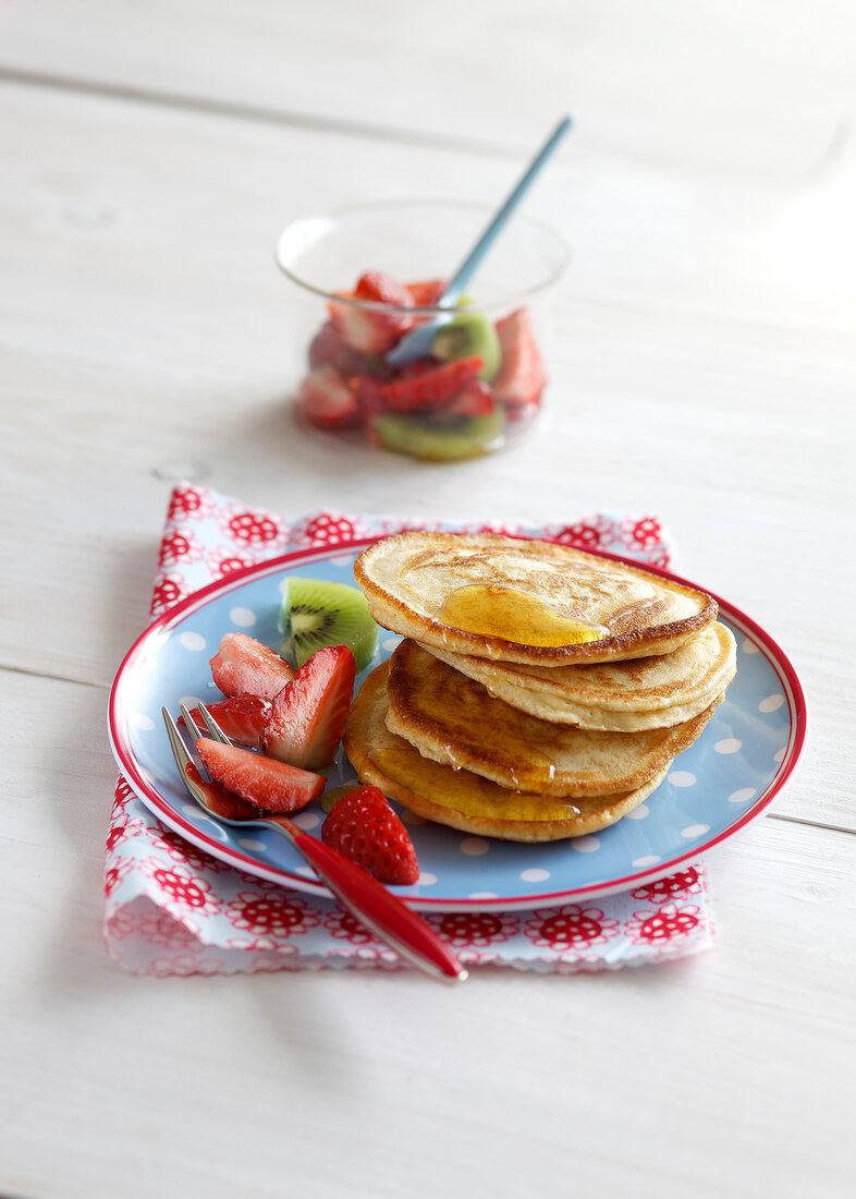 Pancakes with strawberry salad on plate